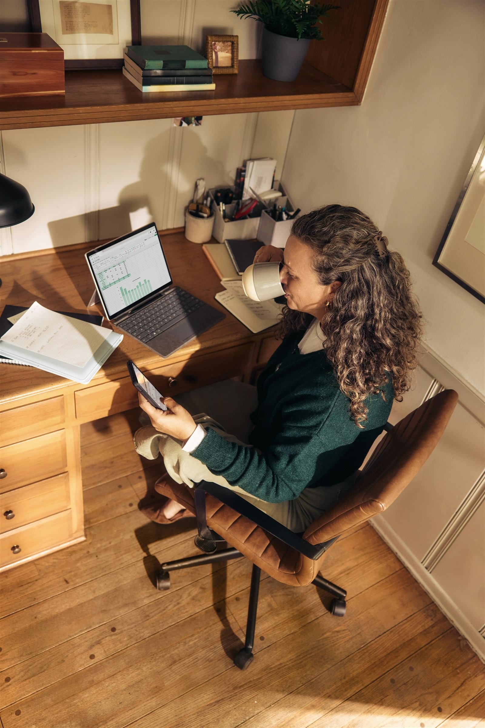 Business owner working in a home office with Microsoft 365 on a laptop