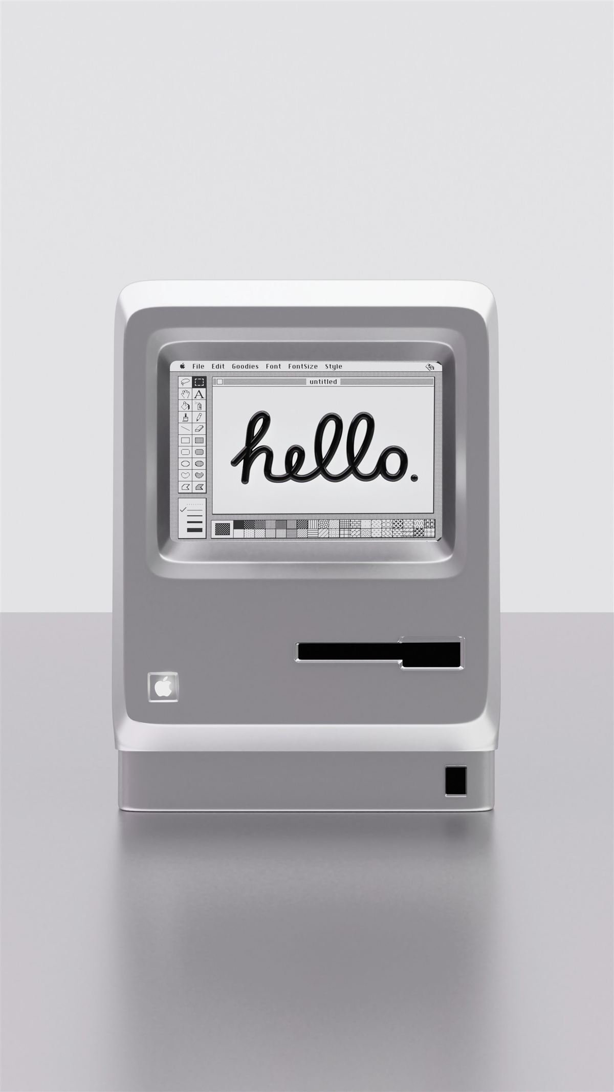 A classic Macintosh computer displaying the word hello