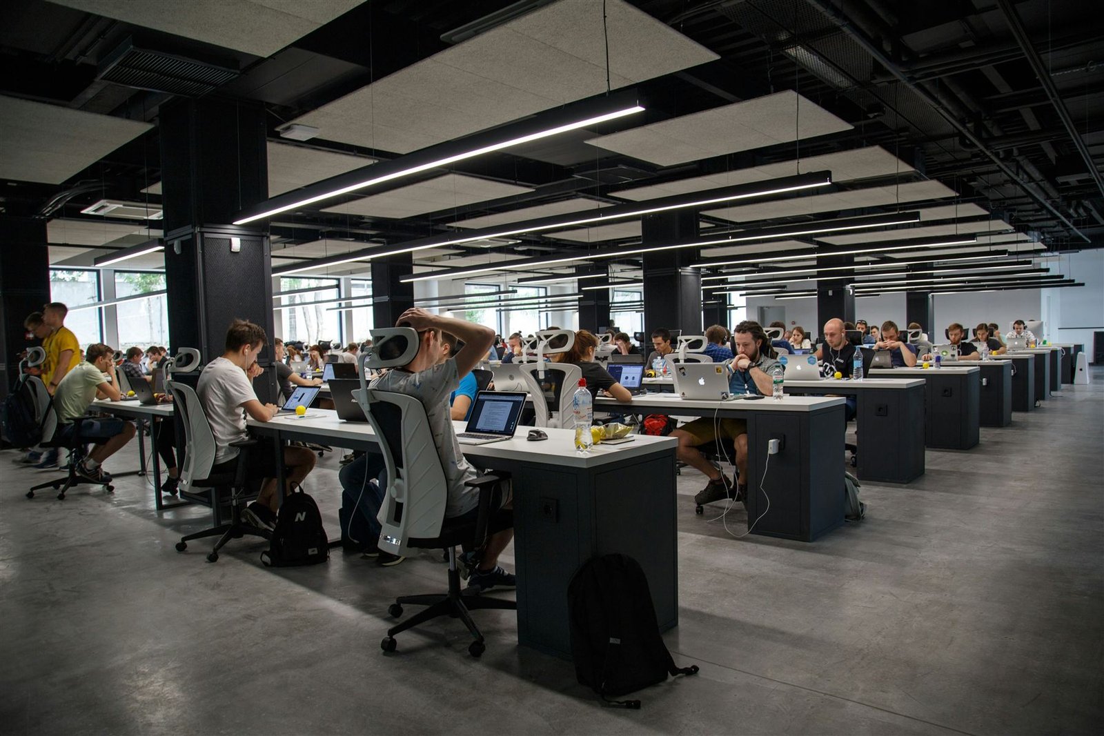 A busy modern office of people working at their computers